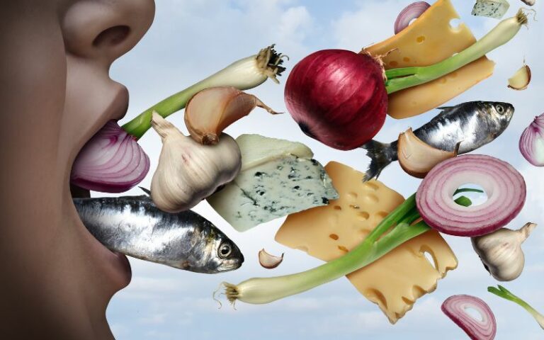 A woman combatting bad breath with food.