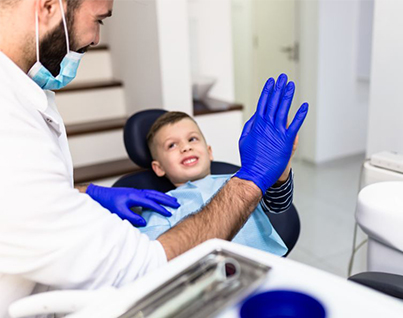Hamilton dentist giving kid a high five after first teeth cleaning in hamilton teeth cleaning