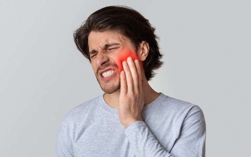 man has a toothache at emergency dental in hamilton