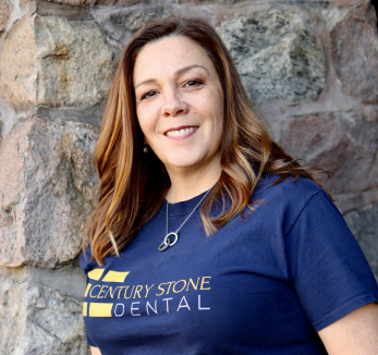 A woman wearing a t - shirt that says century stone dental.