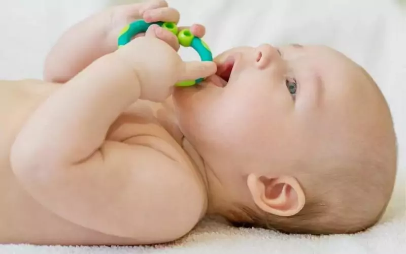 baby using a teething toy