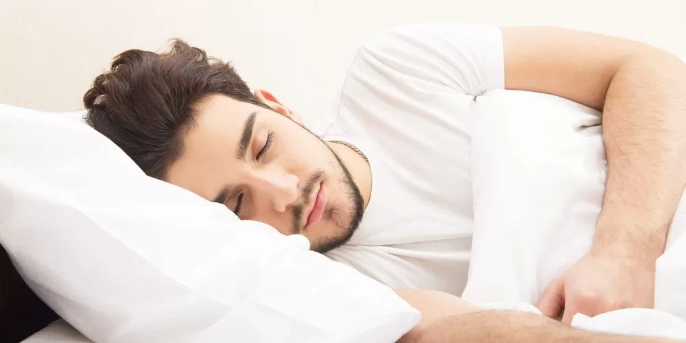 Young man sleeping soundly using Snoring Devices Hamilton