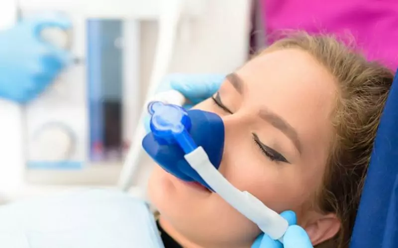 Calm patient wearing sedation mask at dental office at sedation dentistry in hamilton