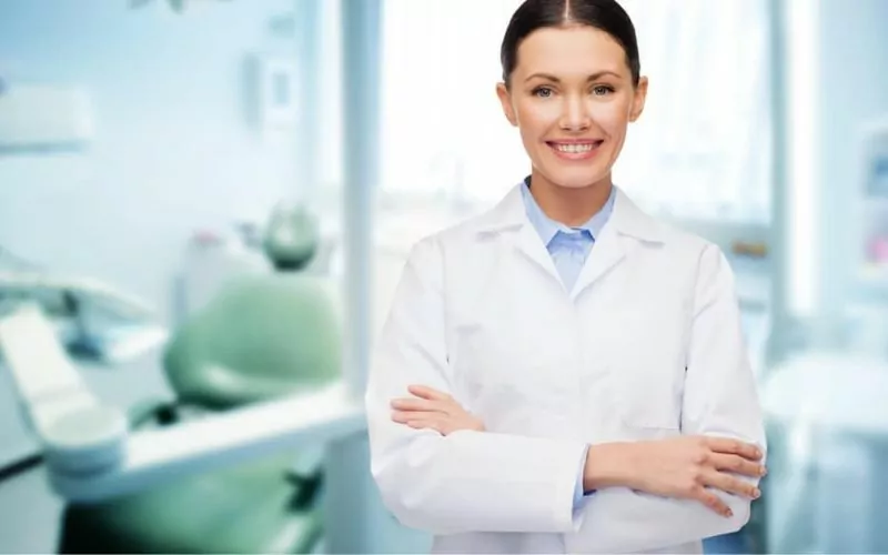 happy young female dentist with tools hamilton