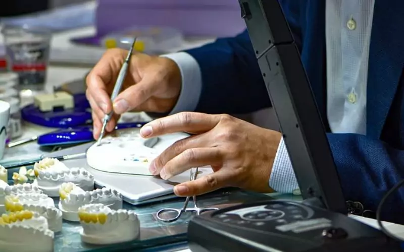 cosmetic dentist creating dental crowns for patient