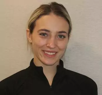 A woman in a black shirt smiling for the camera.