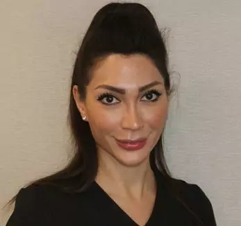 A woman in a black shirt posing for a photo.