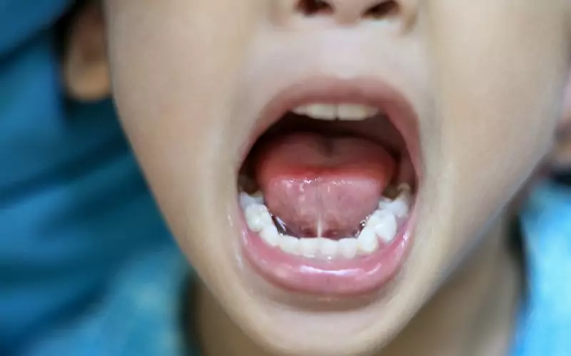 A close up of a child's tongue out.