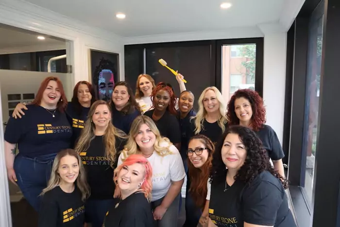 A group of women posing for a photo in a salon.