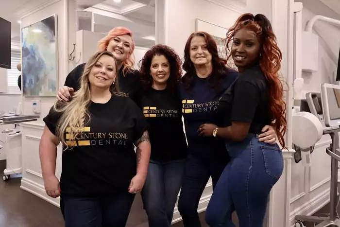A group of women posing for a photo in a dental office.