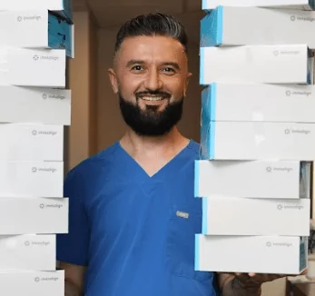 A man holding a stack of boxes in front of him.
